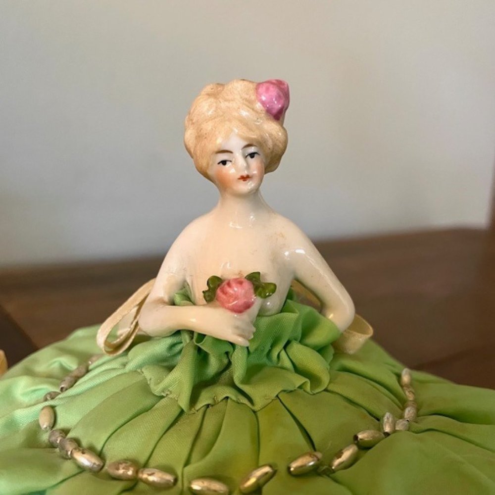 Antique porcelain figural skirted pincushion